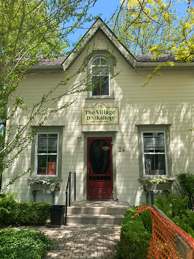 The Village Book Shop - a small, two story building with yellow siding. Located at 24 Main Street North, Bayfield, ON.