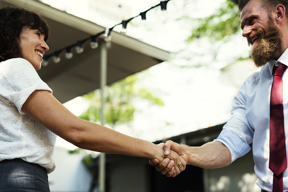 woman and man shaking hands