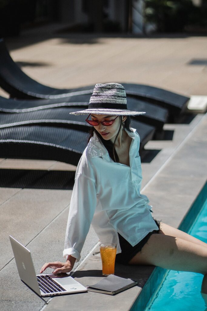 Woman working by a pool. 